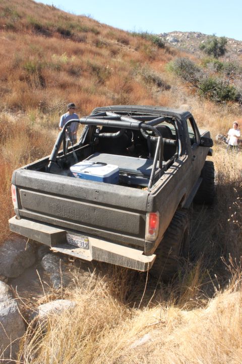 1992 Ford Bronco - This 1992 Ford Bronco is equipped with a roll cage and appears to be navigating a challenging off-road trail.