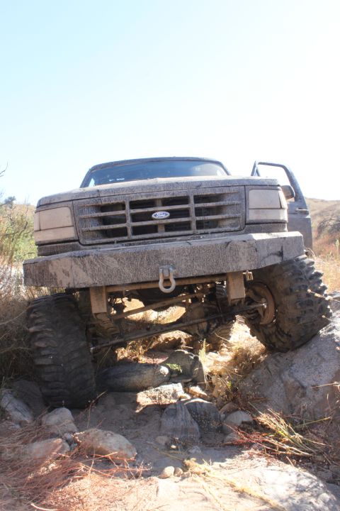 1992 Ford Bronco - A heavily modified Ford Bronco navigates a rocky off-road course.