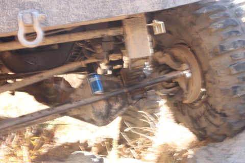 1992 Ford Bronco - Close-up of vehicle undercarriage, suspension parts and an oil filter. Supermotors.net logo is present.