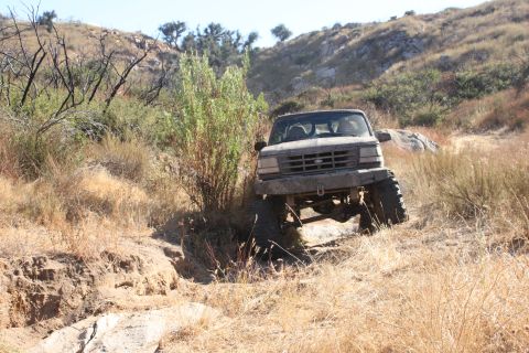 1992 Ford Bronco - This 1992 Ford Bronco tackles rough terrain on a dry, grassy hillside.