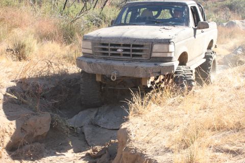 1992 Ford Bronco - This 1992 Ford Bronco is shown off-roading on a dry, brush-filled trail.