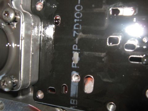 2001 Ford Expedition - A close-up view of a transmission valve body, showing internal components and some fluid residue.