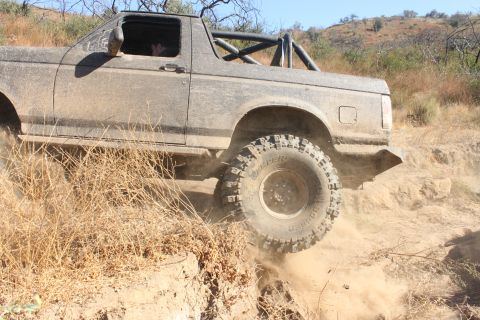 1992 Ford Bronco - This 1992 Ford Bronco navigates a dusty, off-road trail with its tires kicking up dirt.