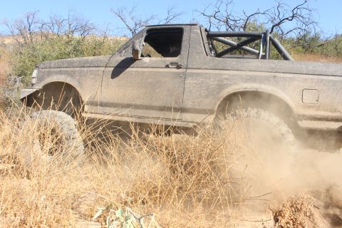 1992 Ford Bronco - This 1992 Ford Bronco is shown navigating a dusty, off-road trail.