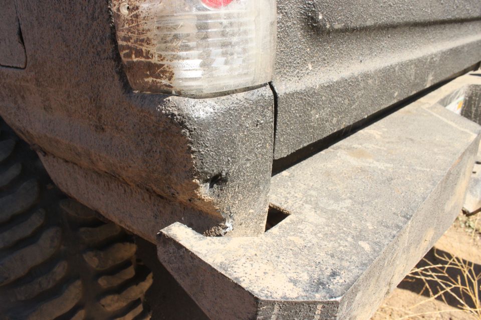 Rear bumper and taillight of a dirty SUV