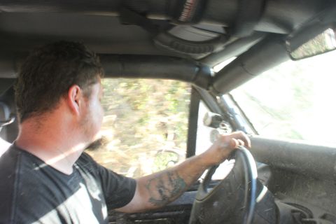 1992 Ford Bronco - A man drives a vehicle through a wooded area, with the "SUPERMOTORS" logo visible on the lower right.