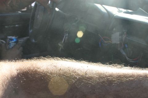 1992 Ford Bronco - The interior of a vehicle shows exposed wiring and a can of soda on the dashboard.