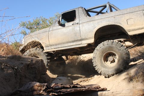 1992 Ford Bronco - This 1992 Ford Bronco navigates a challenging off-road course with large tires and a roll cage.