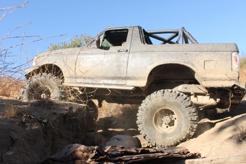 1992 Ford Bronco - This 1992 Ford Bronco navigates a challenging off-road trail with its suspension lifted high.