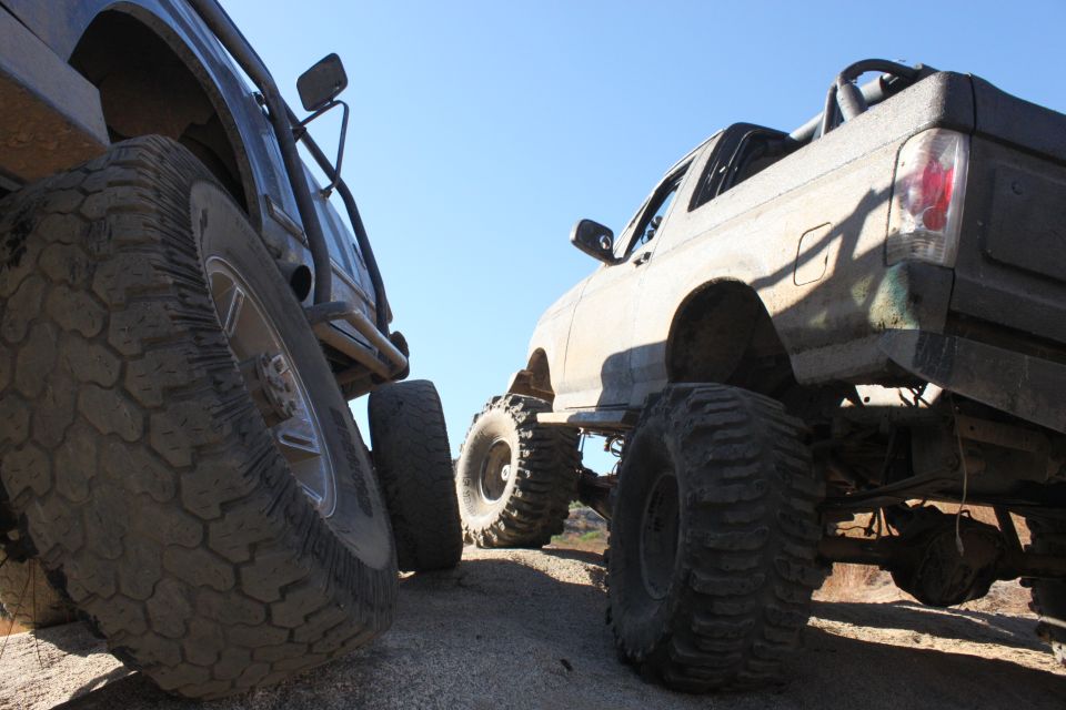 Rear view of a lifted 1992 Ford Bronco next to another off-road truck