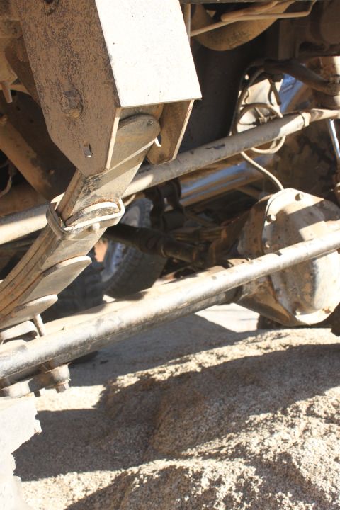 1992 Ford Bronco - Close-up view of a vehicle's undercarriage, revealing suspension and drivetrain components.