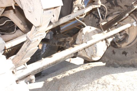 1992 Ford Bronco - Close-up view of the rear axle and suspension components of an off-road vehicle.