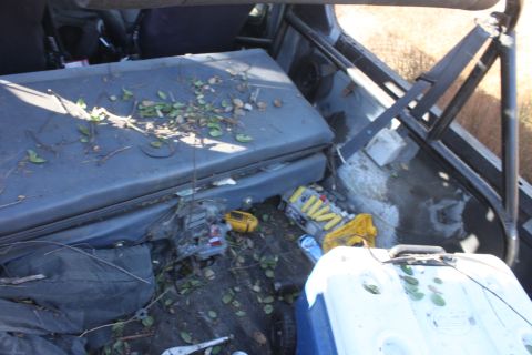 1992 Ford Bronco - Debris and personal items are stored inside the vehicle's interior.
