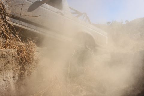1992 Ford Bronco - Ford Bronco navigates a dusty, off-road trail.