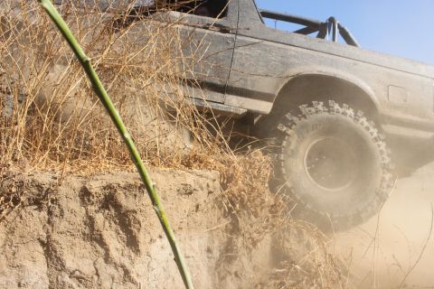1992 Ford Bronco - This 1992 Ford Bronco navigates a steep dirt incline, kicking up dust.