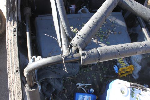 1992 Ford Bronco - The interior of a vehicle shows a roll cage and various items scattered on the floor.