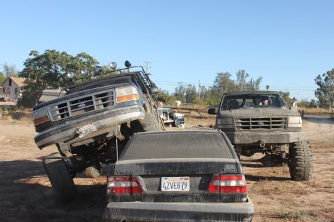 1992 Ford Bronco tilted on its side, front grille visible