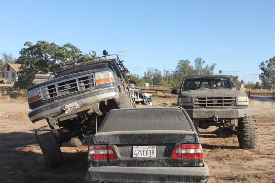1992 Ford Bronco tilted on its side, front grille visible
