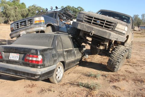1992 Ford Bronco on top of a black Volvo sedan, front view
