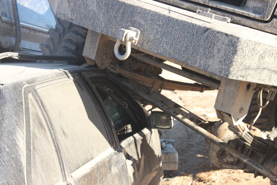 Large truck crushing a car, showing suspension and tire details