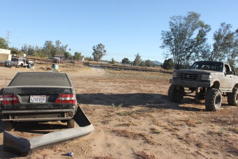 Gray 1992 Ford Bronco lifted with large tires, viewed from the front-right