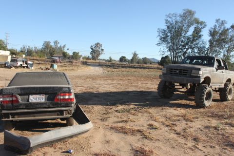Lifted 1992 Ford pickup truck with large tires, front view
