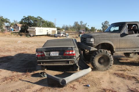 1992 Ford Bronco crushing a sedan, front 3/4 view