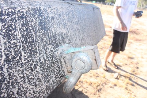 Close-up of a tow hitch on a dirty vehicle bumper