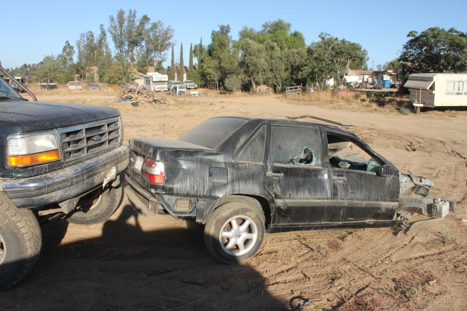 Ford F-Series truck front end bumper close to a wrecked black sedan