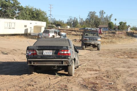 1992 Ford Bronco with roof rack parked on dirt road