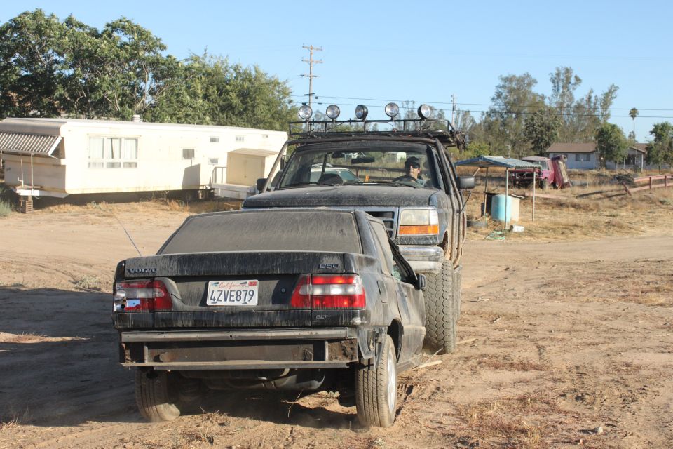 1992 Ford Bronco pushing black sedan with California plates