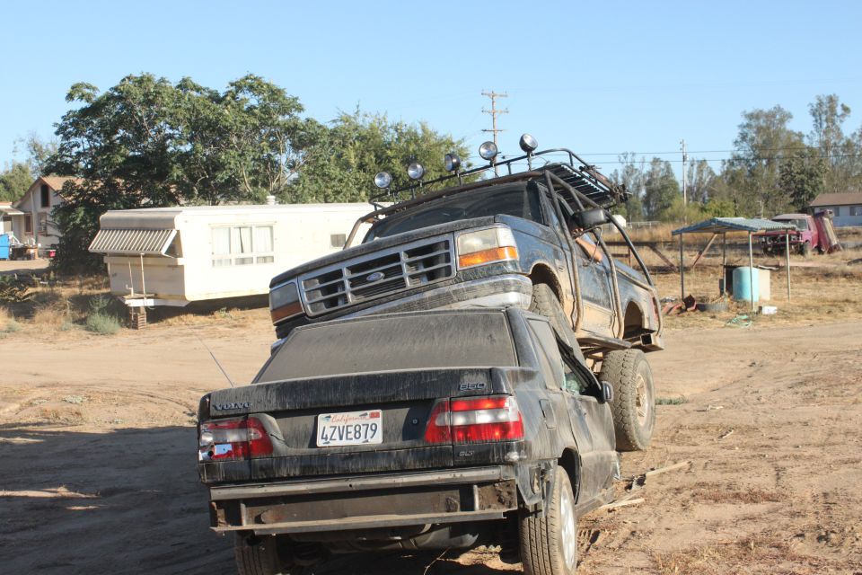1992 Ford Bronco front grille and roof rack, on top of a black Volvo sedan