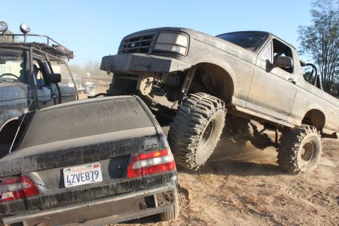 1992 Ford Bronco crushing a Volvo sedan, front grille visible