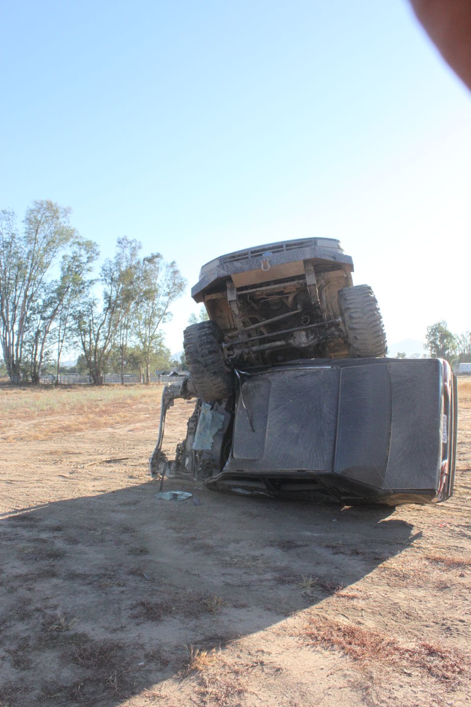 SUV flipped on its side in a dirt lot
