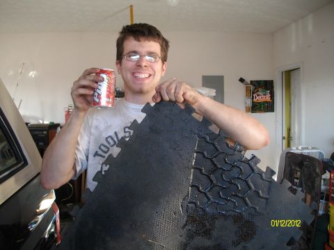 1990 Ford Bronco - A man poses with a drink and a floor mat that resembles a tire tread pattern.