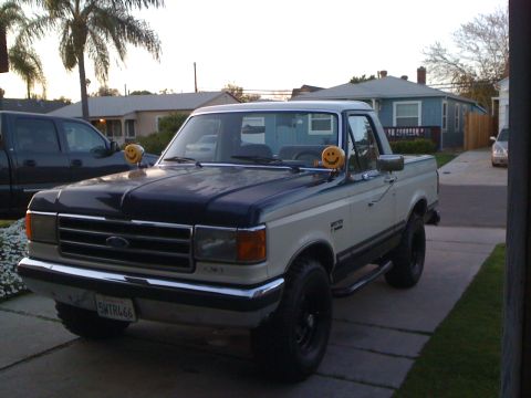 1989 Ford Bronco - This 1989 Ford F-150 pickup truck features a two-tone paint scheme and is adorned with novelty smiley face hood ornaments.