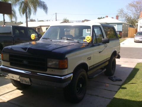 1989 Ford Bronco - This 1989 Ford Bronco features a two-tone paint scheme and is viewed from the front three-quarter angle.