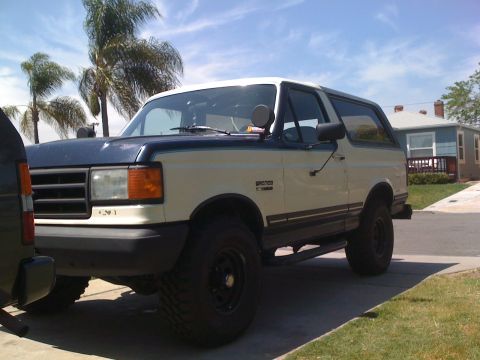 1989 Ford Bronco - This 1989 Ford Bronco is parked in a residential driveway under a partly cloudy sky.