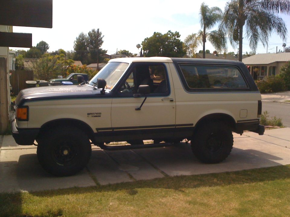 1989 Ford Bronco parked on a driveway, side view