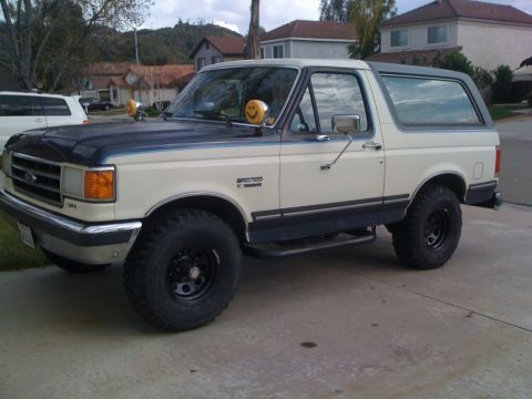 1989 Ford Bronco - This 1989 Ford Bronco features a two-tone paint scheme and is viewed from the front three-quarter angle.
