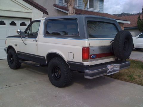 1989 Ford Bronco - This 1987 Ford Bronco is seen from its rear three-quarter view, parked in front of a garage.