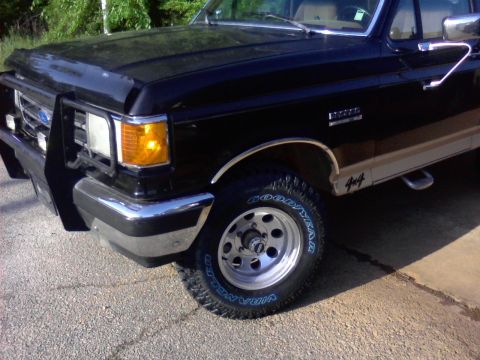 1990 Ford Bronco - This 1990 Ford Bronco features a prominent chrome grille guard and bumper, along with 4x4 badging.