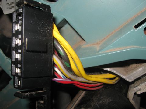 1981 Ford Bronco - A close-up view of a vehicle's electrical wiring harness connector and associated wires.