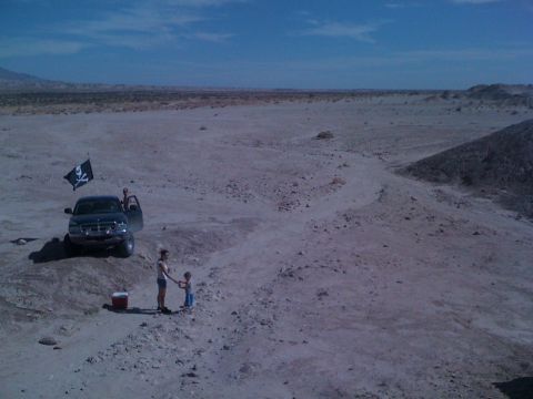 1989 Ford Bronco - A family enjoys a day out in the desert with their truck and a pirate flag.