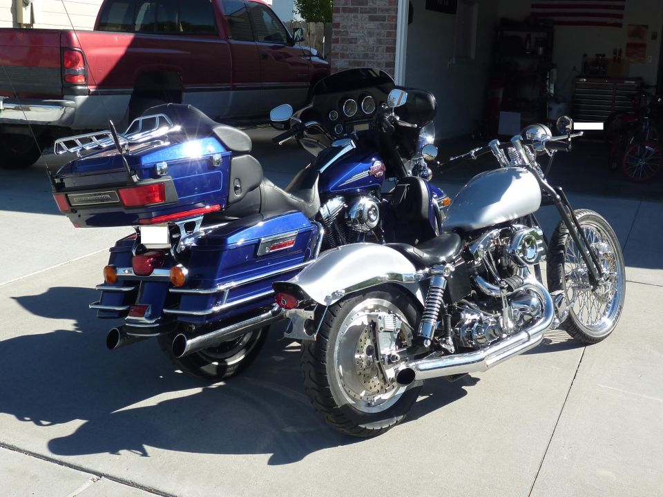 Blue Harley-Davidson Electra Glide Clsc rear view, parked next to a silver motorcycle