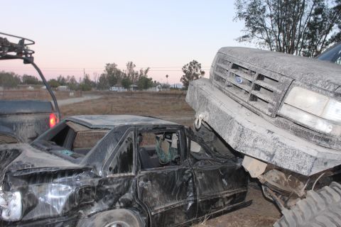 1992 Ford Bronco grille over wrecked black sedan