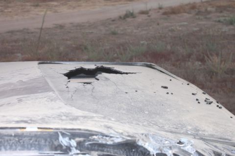 Damaged roof of a vehicle with a large hole