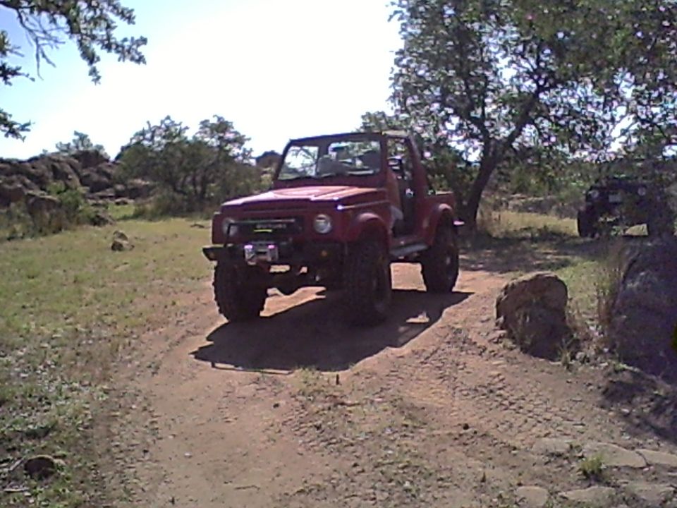 Red off-road vehicle with winch on a dirt path