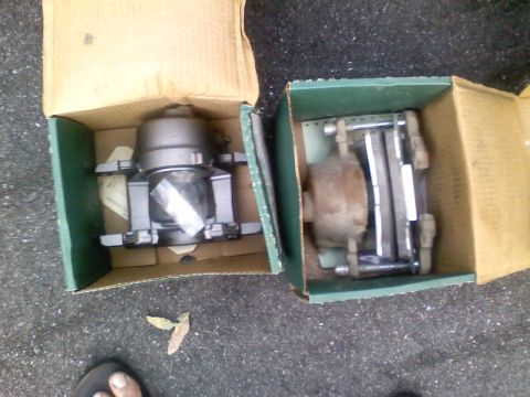 1990 Ford Bronco - New and used brake calipers shown in their original packaging.