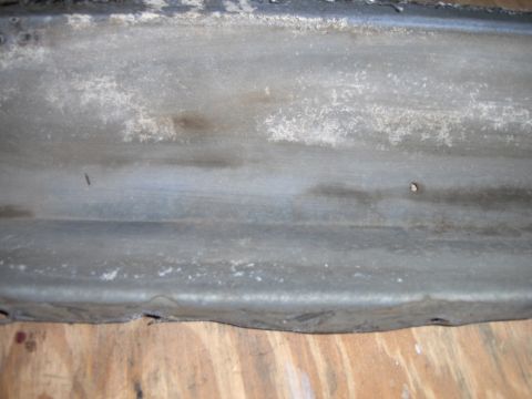 1970 Chevrolet Camaro - Close-up of a weathered metal automotive part, showing texture and wear.
